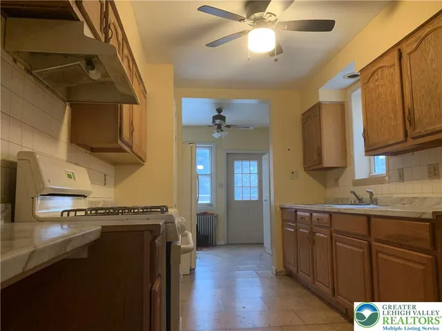 a kitchen with a sink a cabinets and appliances