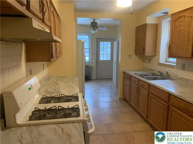 a kitchen with a stove and a refrigerator