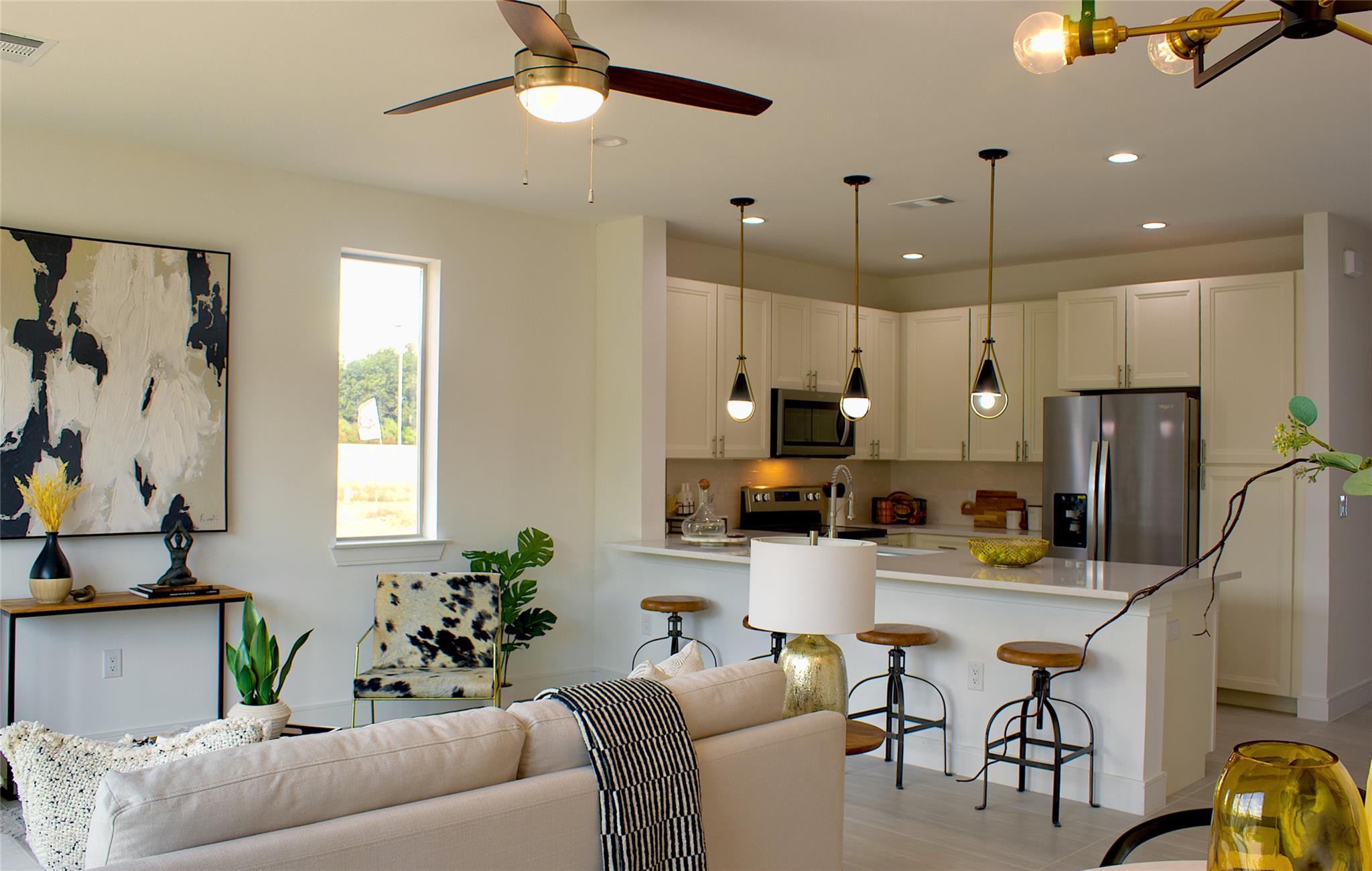 300 Tesla Circle Austin, TX 78681 - Photo 11 of 39 Open-concept living area with integrated kitchen, featuring light wood-finish flooring and recessed lighting