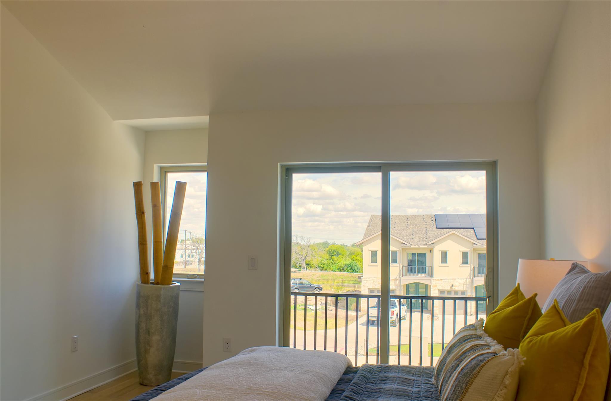 300 Tesla Circle Austin, TX 78681 - Photo 22 of 39 Spacious interior featuring light wood-finish flooring, white walls, and a large sliding glass door opening to a balcony