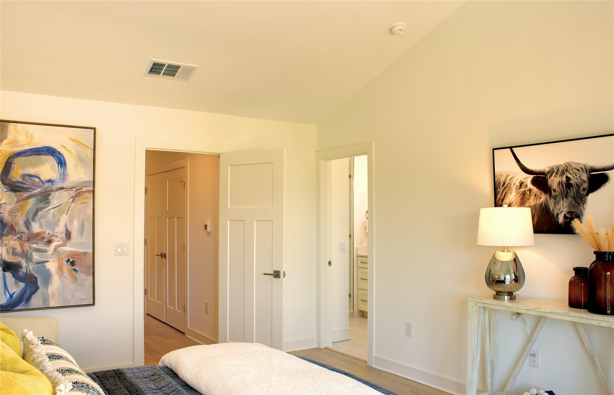 300 Tesla Circle Austin, TX 78681 - Photo 24 of 39 Vaulted ceiling room with light wood-finish flooring, featuring a three-panel interior door and a recessed doorway