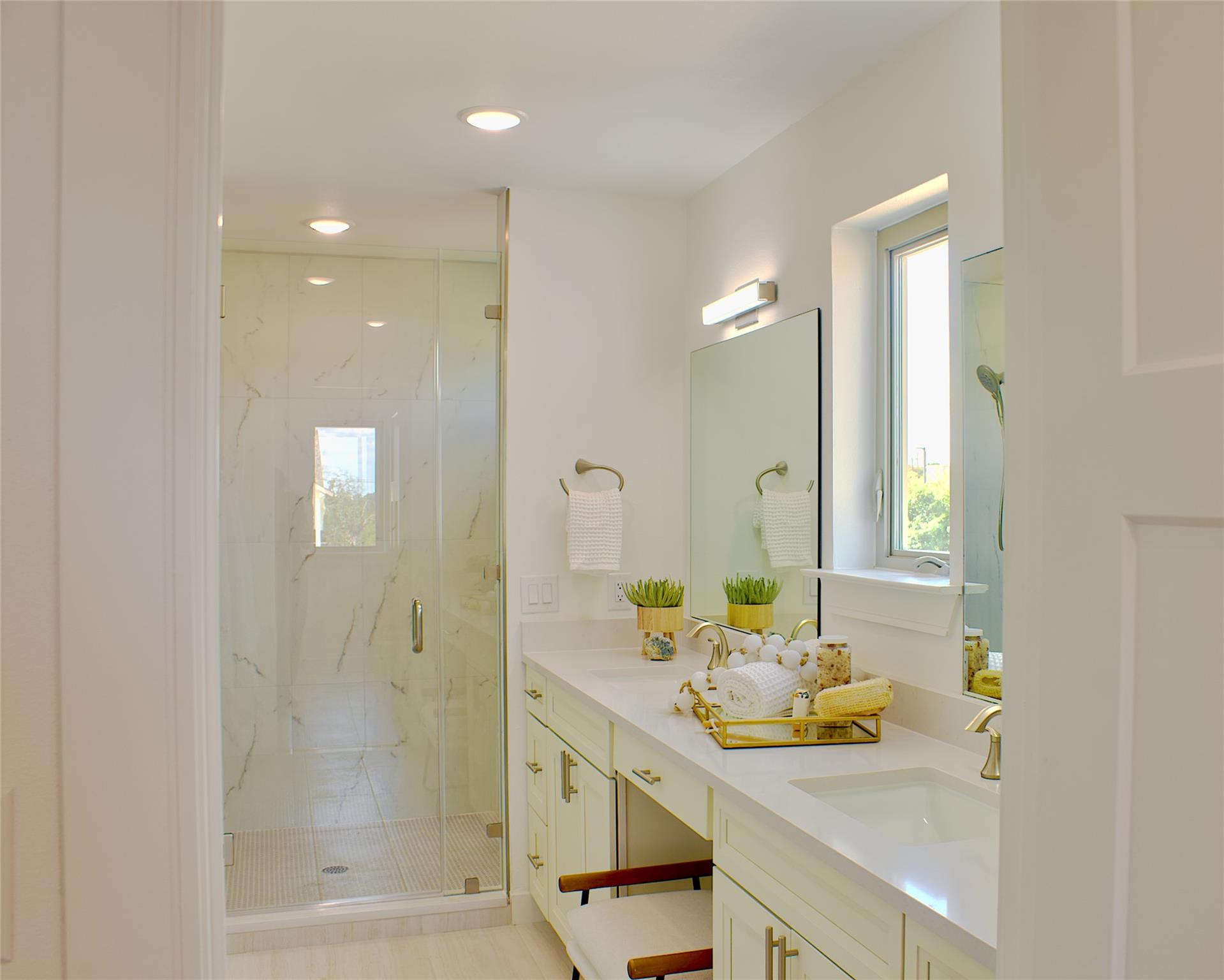300 Tesla Circle Austin, TX 78681 - Photo 27 of 39 Dual vanity with integrated sinks, light-toned cabinetry, and gold-finish fixtures