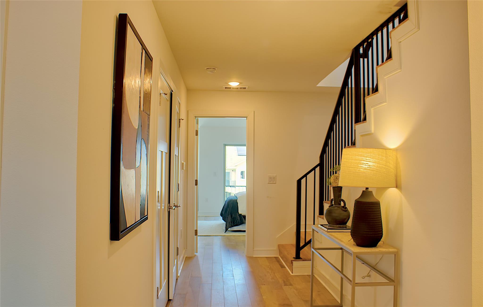 300 Tesla Circle Austin, TX 78681 - Photo 30 of 39 Hardwood-finish flooring extending through a brightly lit hallway