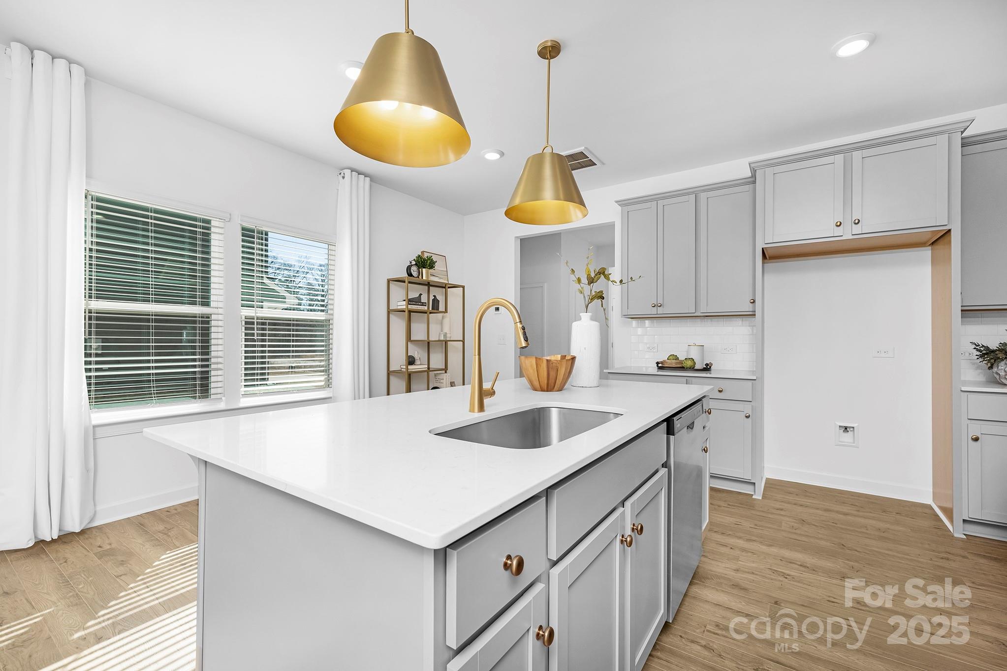2125 Tom Sadler Road, Unit 7159 Charlotte, NC 28214 - Photo 5 of 26 a kitchen with a sink a center island and cabinets