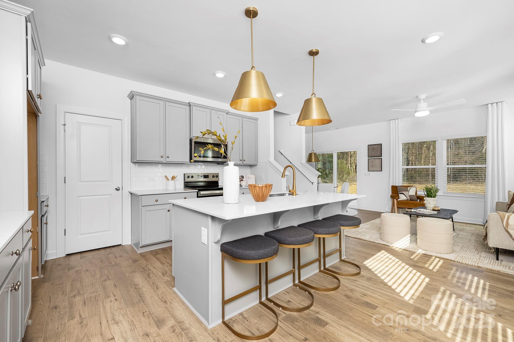 2125 Tom Sadler Road, Unit 7159 Charlotte, NC 28214 - Photo 6 of 26 a kitchen with stainless steel appliances granite countertop a sink a stove and a wooden floors