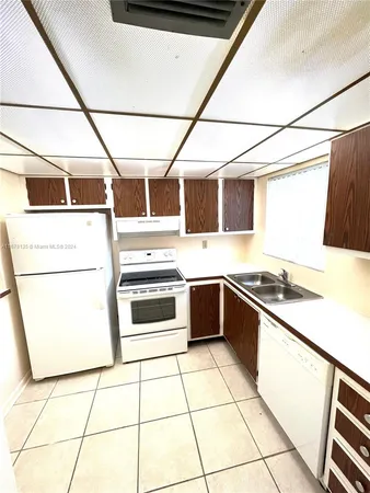 a kitchen with granite countertop a stove and a microwave