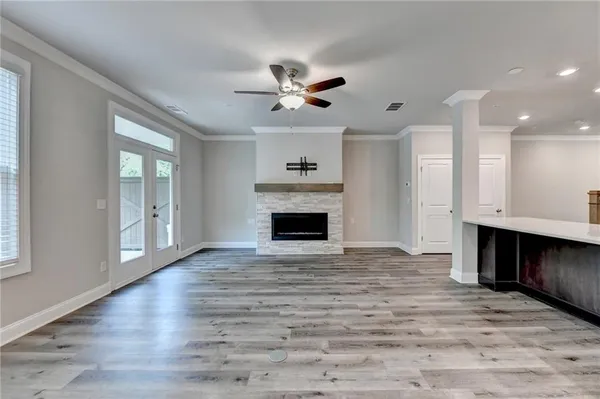 a view of an empty room with a fireplace and a window
