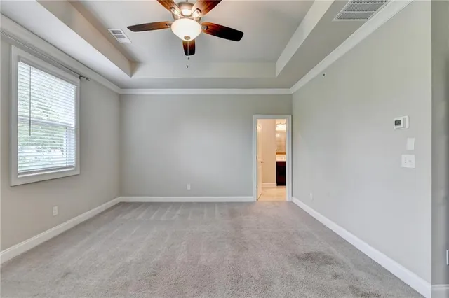 an empty room with closet and windows