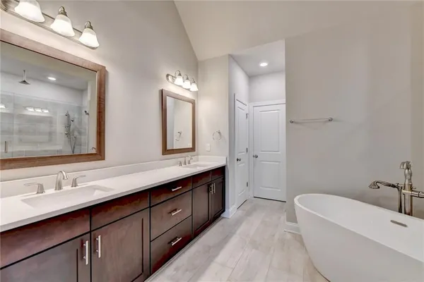 a bathroom with double vanity sinks and a mirror