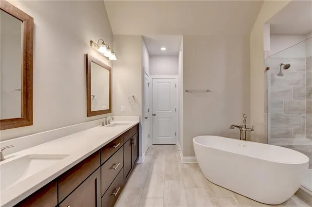 a spacious bathroom with a double vanity sink mirror and shower
