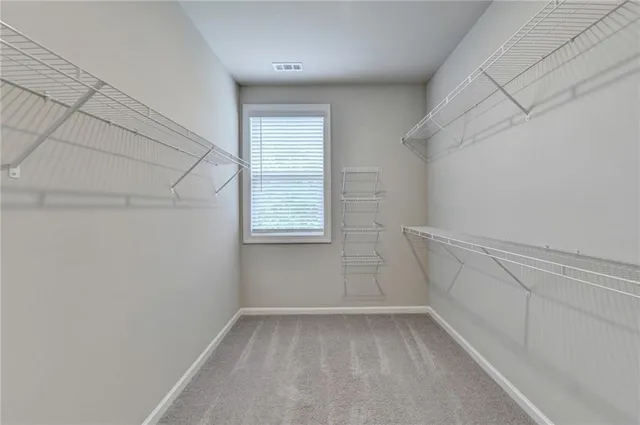 a bathroom with a granite countertop sink a toilet a mirror a bathtub and shower