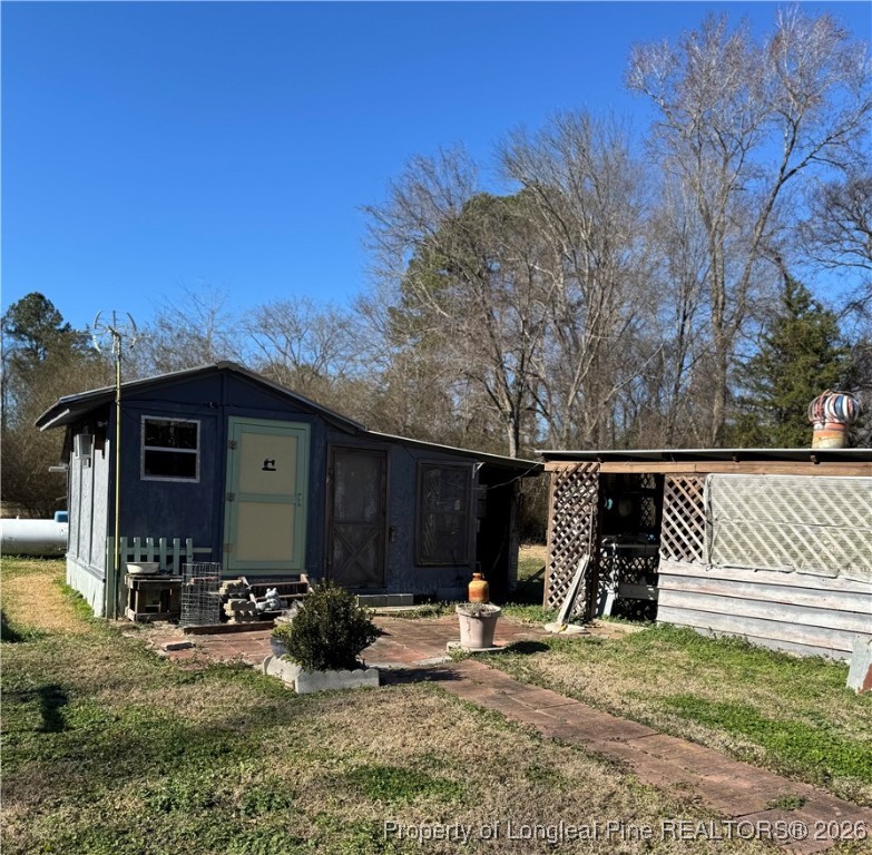 159 Zimmerman Road Sanford, NC 27330 - Photo 7 of 21 a view of a house with backyard and sitting area