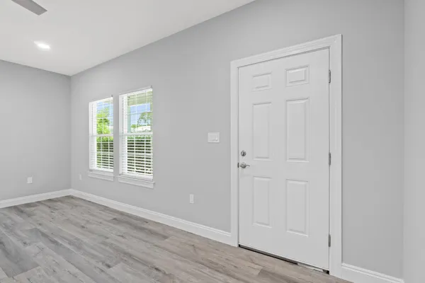 a view of a hallway with wooden floor