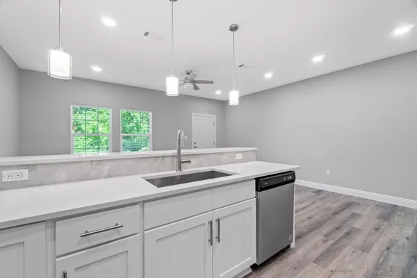 a kitchen with cabinets stainless steel appliances and a sink