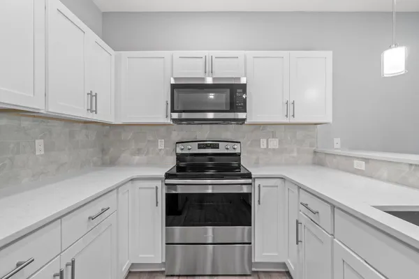 a kitchen with a sink and chandelier