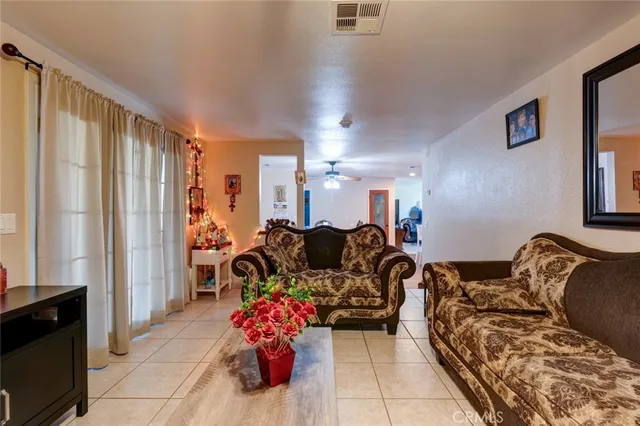 a living room with furniture and a large mirror