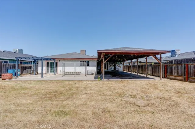a view of house with backyard and seating space