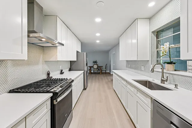 a kitchen with a sink stove and cabinets