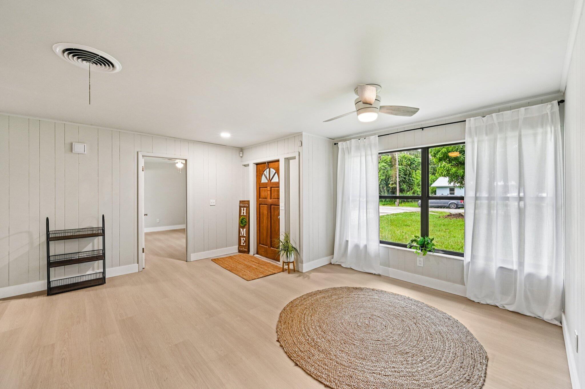 5852 Southeast Wesley Avenue Stuart, FL 34997 - Photo 13 of 27 a view of an empty room with a window and a kitchen
