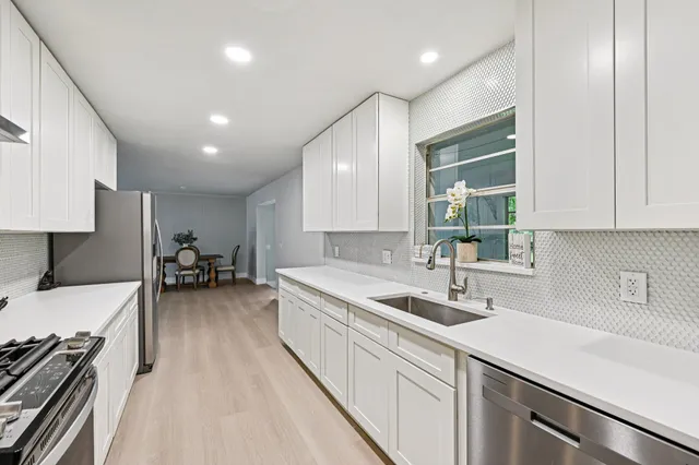 a kitchen with a sink and stove