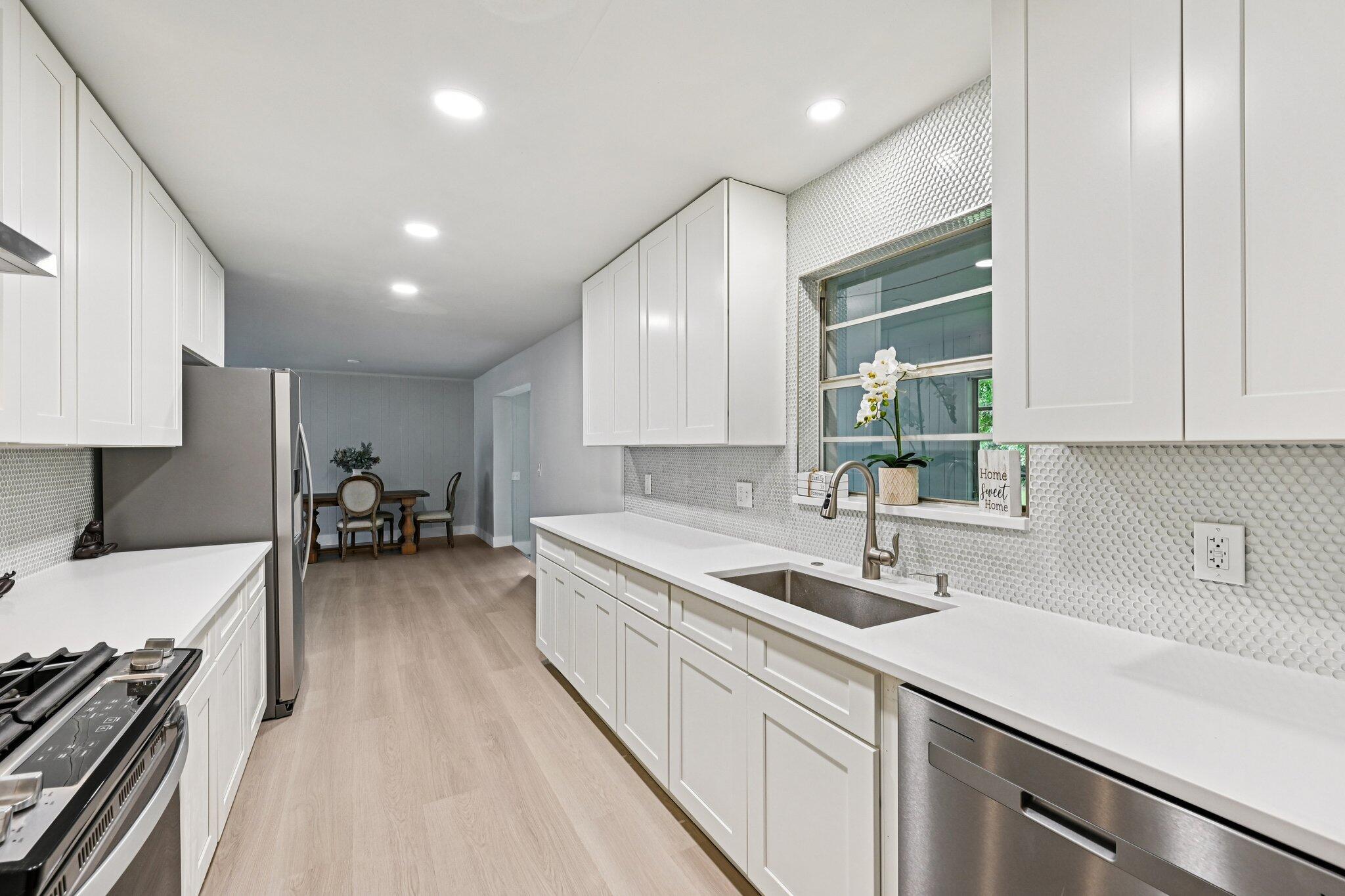 5852 Southeast Wesley Avenue Stuart, FL 34997 - Photo 15 of 27 a kitchen with a sink and stove