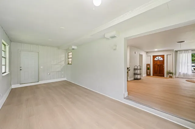 en empty room with windows and entrance