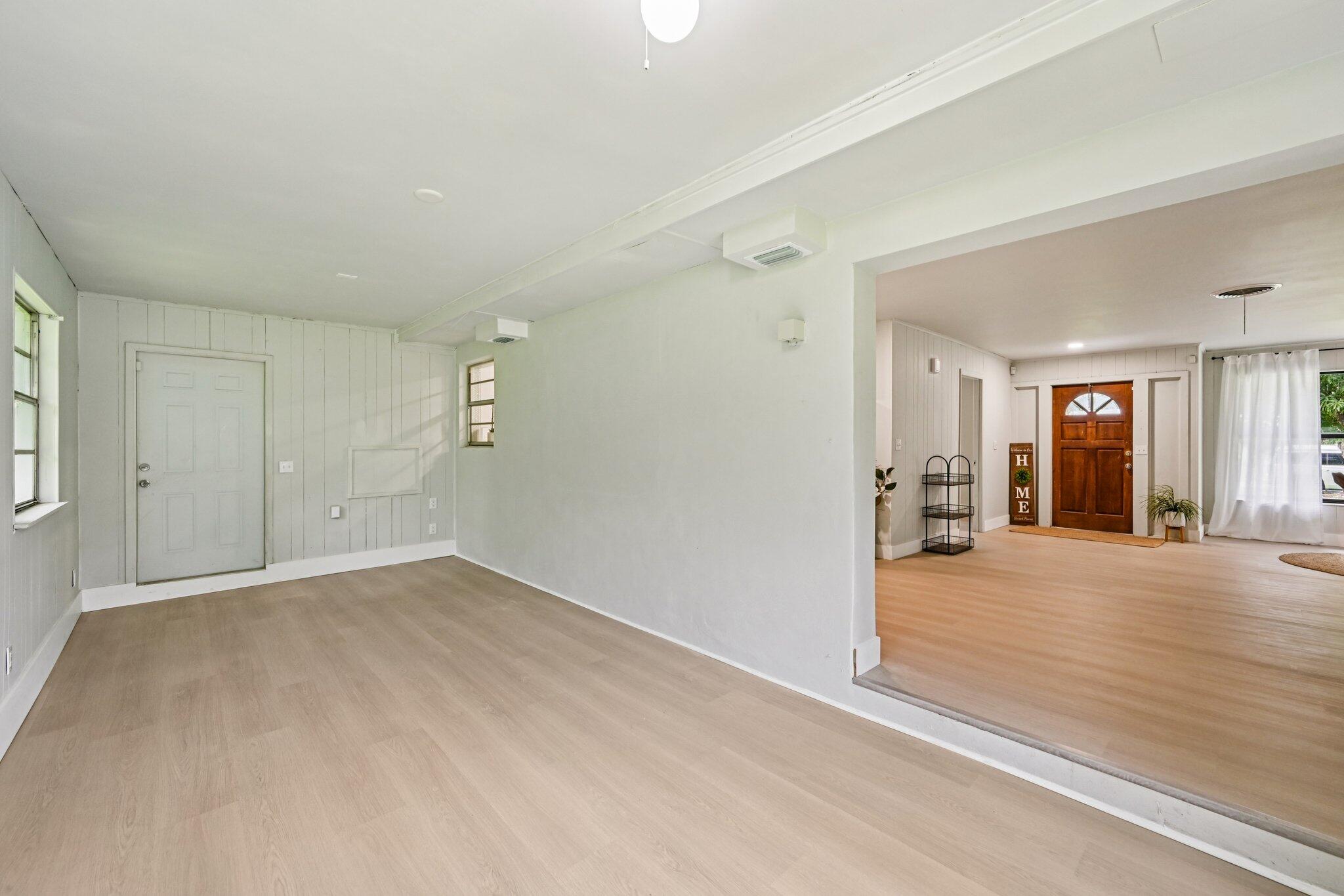 5852 Southeast Wesley Avenue Stuart, FL 34997 - Photo 22 of 27 en empty room with windows and entrance