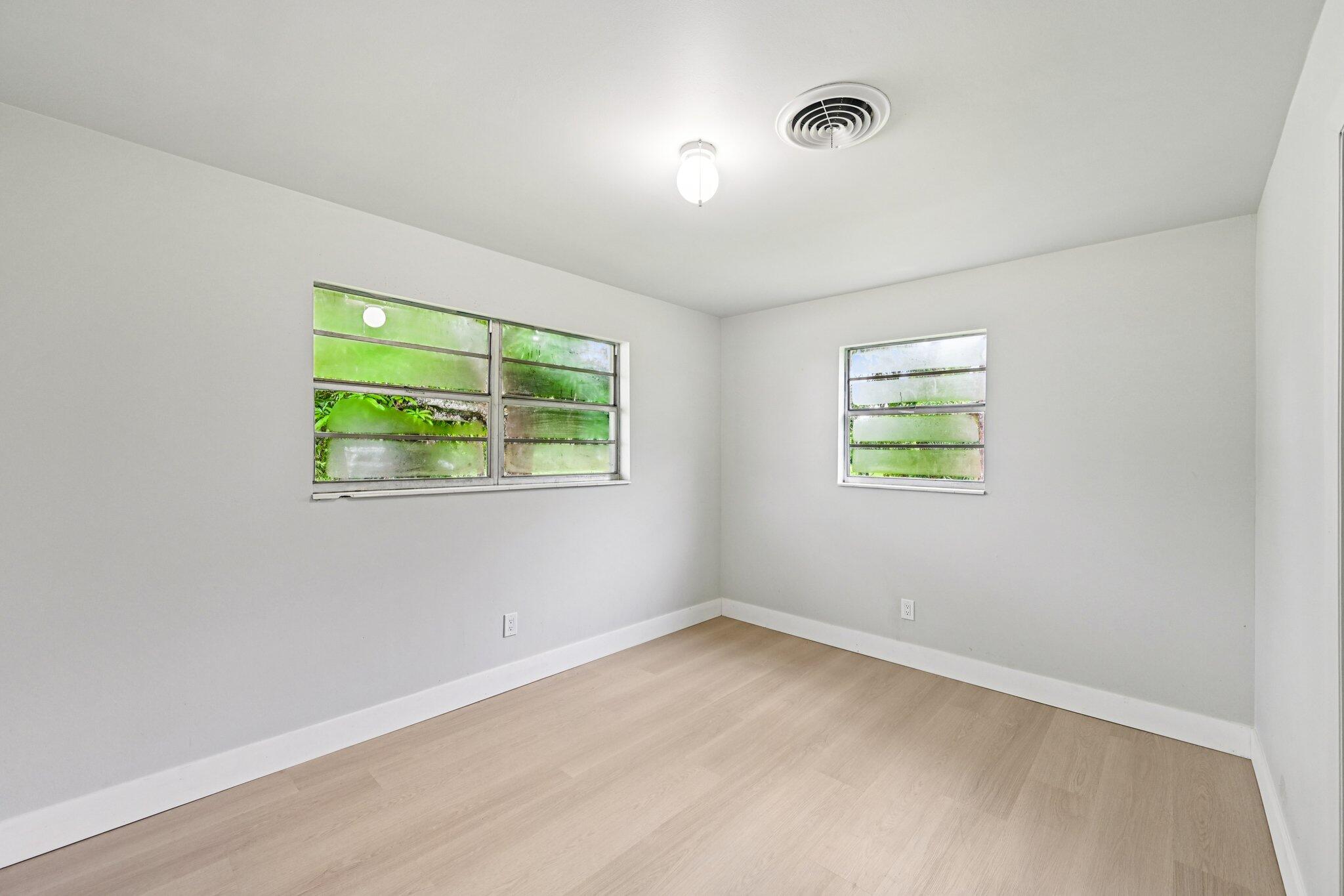 5852 Southeast Wesley Avenue Stuart, FL 34997 - Photo 26 of 27 an empty room with windows and closet