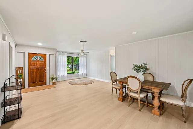 a dining room with furniture and window