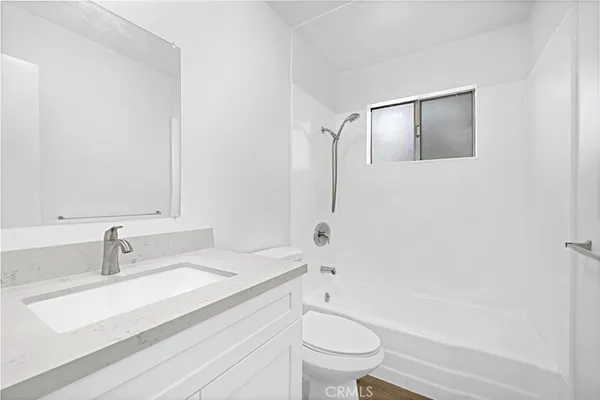 a bathroom with a sink toilet a mirror and shower