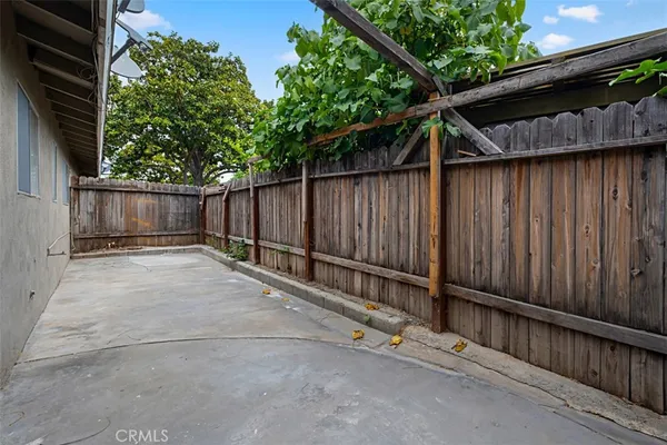 a view of small backyard with wooden fence