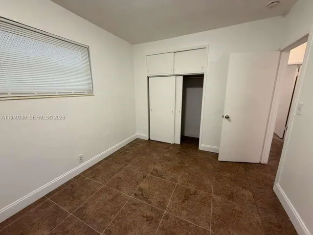 a view of a yard with wooden fence