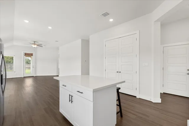 a view of a kitchen cabinets and wooden floor