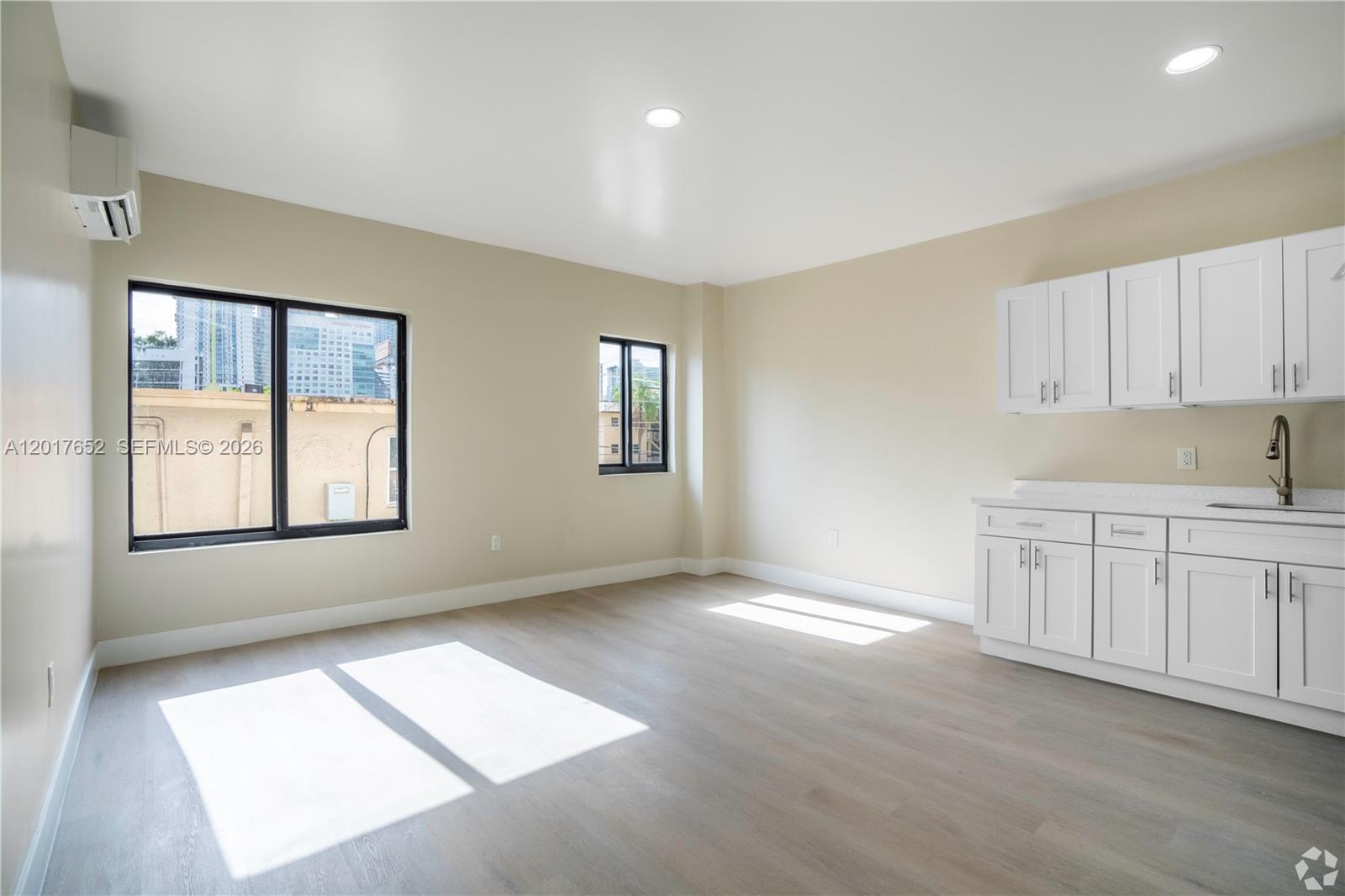 433 Southwest 6th Street, Unit 15 Miami, FL 33130 - Photo 3 of 12 a view of an empty room with window and cabinet