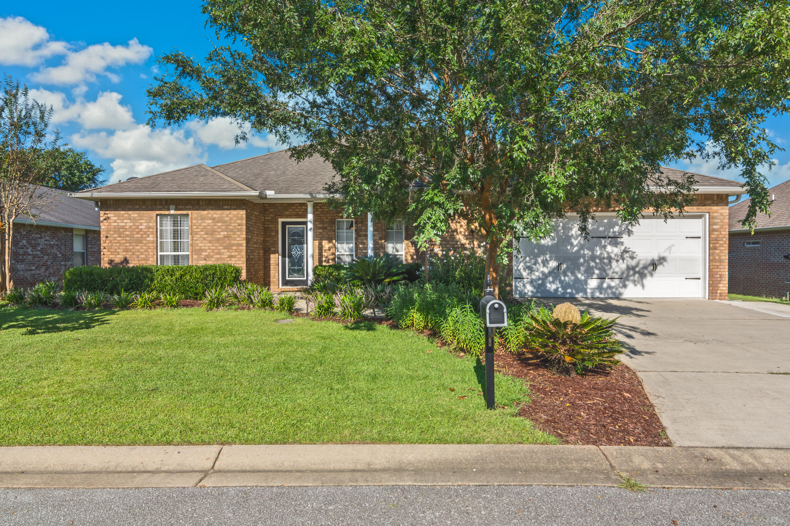 4631 Hermosa Road Crestview, FL 32539 - Photo 1 of 42 a front view of a house with garden