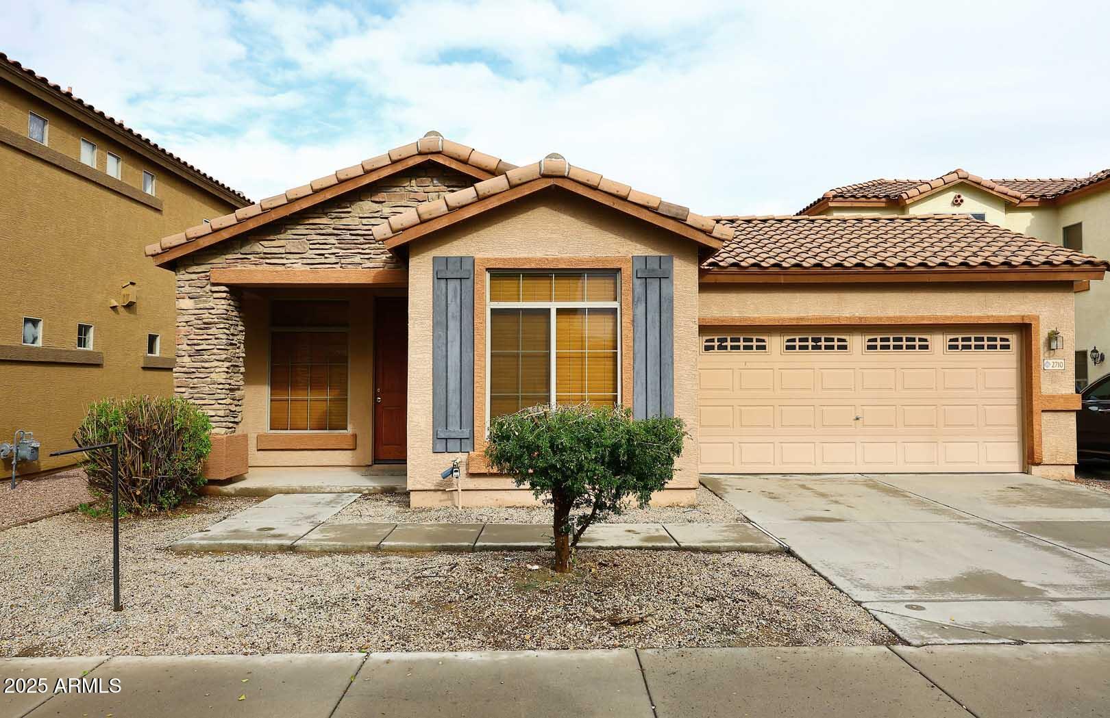 2710 East Chester Drive Chandler, AZ 85286 - Photo 1 of 28 a front view of a house with garden