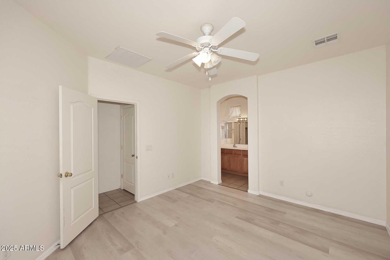 2710 East Chester Drive Chandler, AZ 85286 - Photo 11 of 28 a view of an empty room with chandelier fan and a bathroom