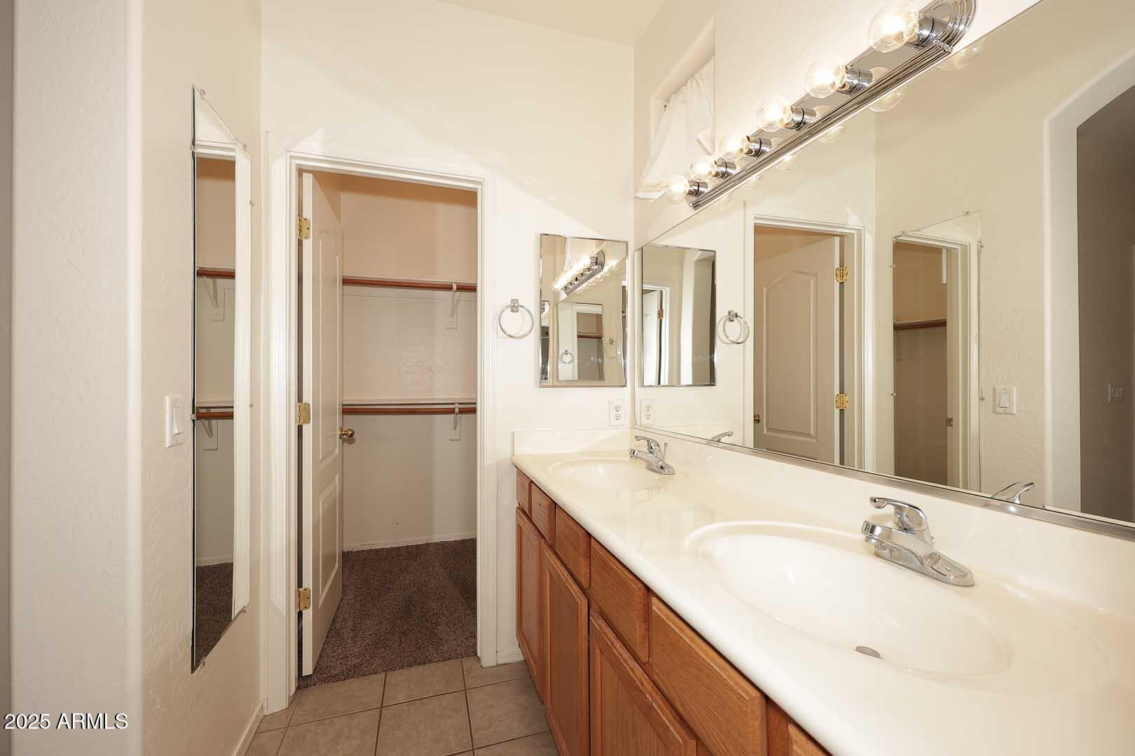 2710 East Chester Drive Chandler, AZ 85286 - Photo 13 of 28 a bathroom with a double vanity sink and mirror