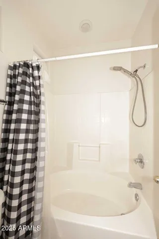 a bathroom with a bathtub and shower