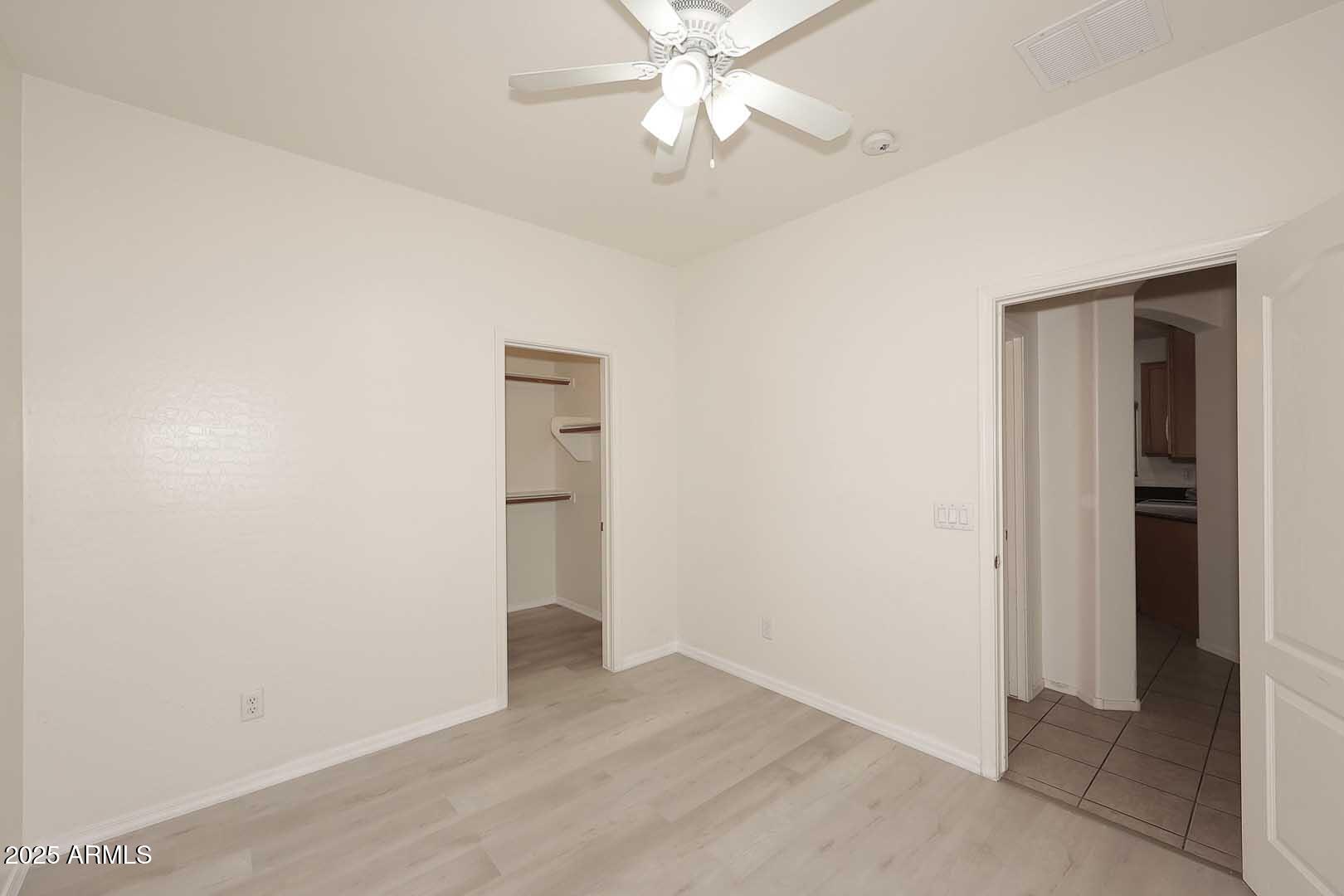2710 East Chester Drive Chandler, AZ 85286 - Photo 17 of 28 an empty room with closet and a ceiling fan