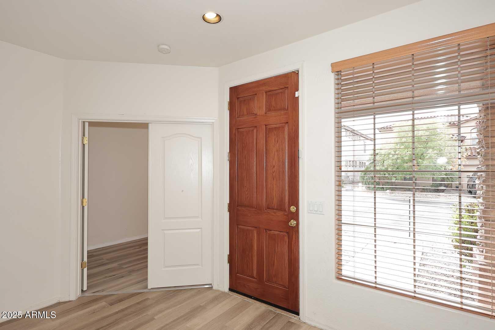 2710 East Chester Drive Chandler, AZ 85286 - Photo 4 of 28 a view of empty room with wooden floor and fan