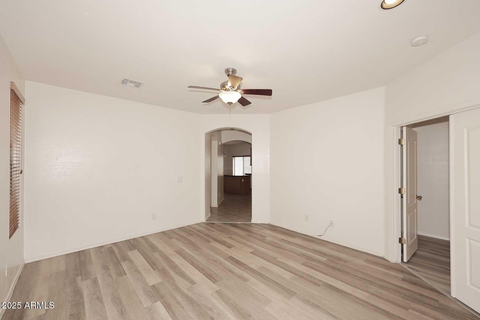 2710 East Chester Drive Chandler, AZ 85286 - Photo 6 of 28 a view of a room with a ceiling fan and hardwood floor