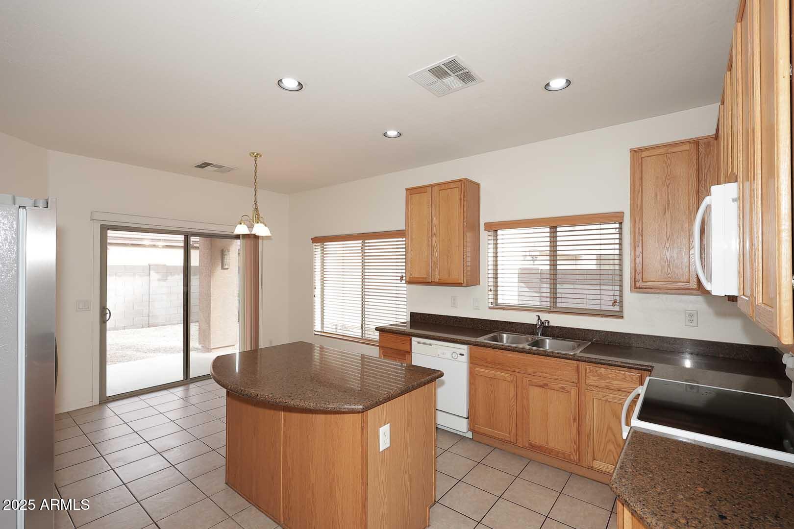 2710 East Chester Drive Chandler, AZ 85286 - Photo 7 of 28 a kitchen with a sink stove and cabinets