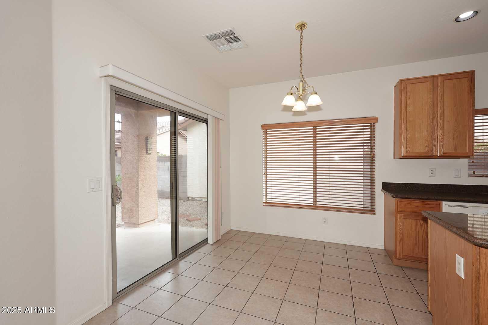 2710 East Chester Drive Chandler, AZ 85286 - Photo 9 of 28 a view of an empty room with a window and a kitchen