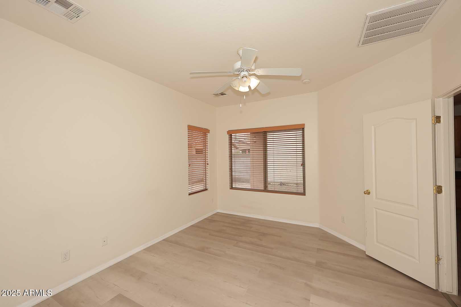 2710 East Chester Drive Chandler, AZ 85286 - Photo 10 of 28 an empty room with windows and fan