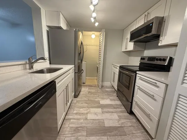 a kitchen with a sink stove and refrigerator