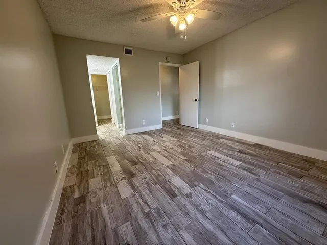 wooden floor in an empty room with a mirror