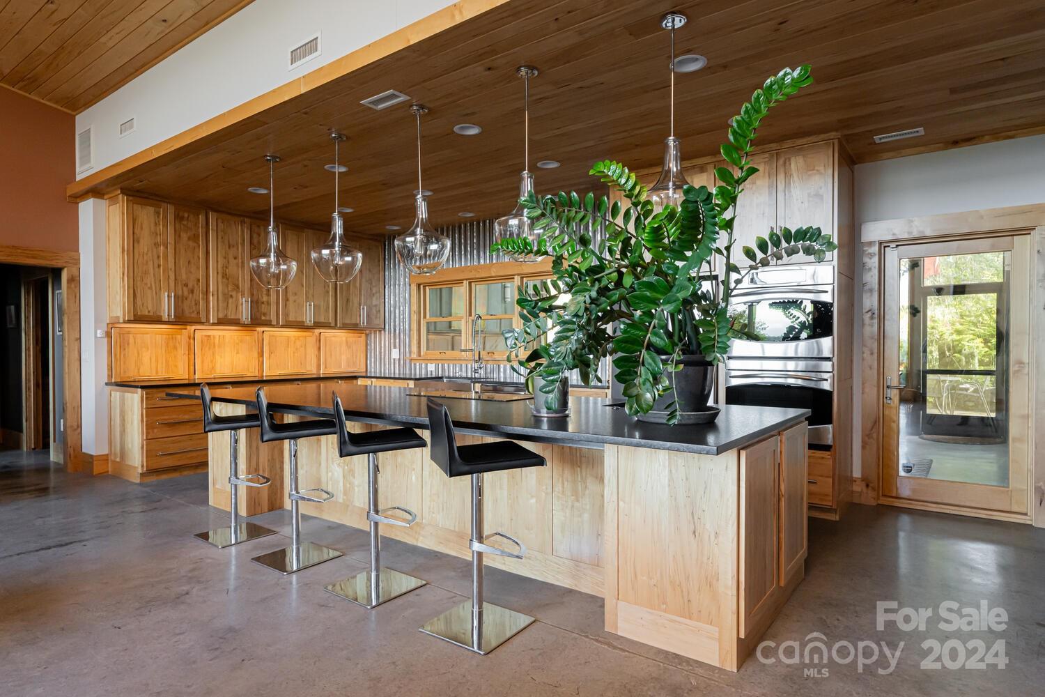 265 Alexander Road Alexander, NC 28701 - Photo 12 of 48 a kitchen with counter and chairs