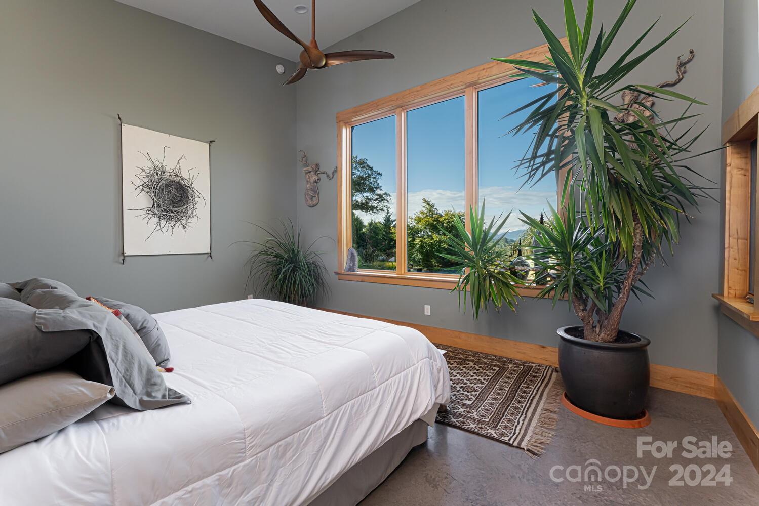 265 Alexander Road Alexander, NC 28701 - Photo 15 of 48 a bedroom with a large bed and a potted plant