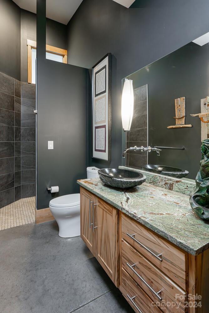 265 Alexander Road Alexander, NC 28701 - Photo 20 of 48 a bathroom with a granite countertop sink a toilet and a mirror